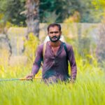 modern farmer working field