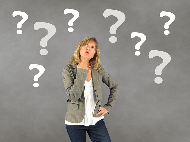 Confused emoji with question marks surrounding it, representing the meaning of WDYM