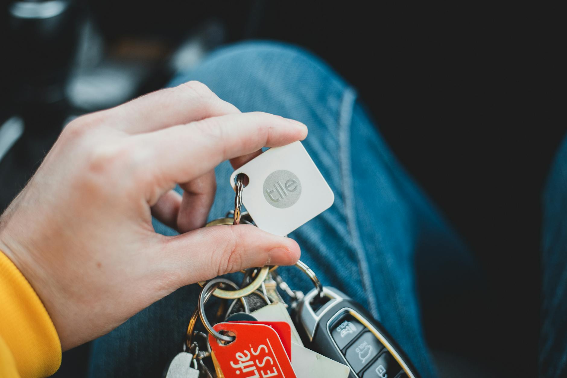 person using keyring finder