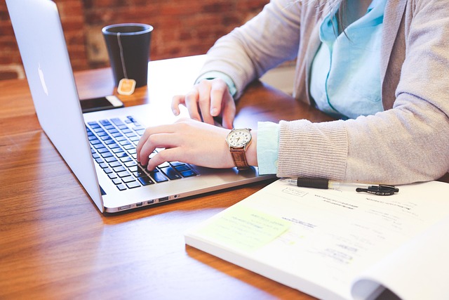 Person writing a job application email on a laptop