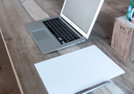 person writing on laptop blog