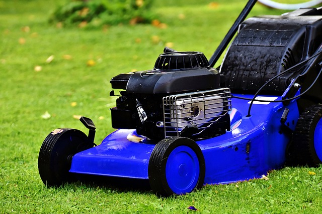 Collapsible lawn mower handles for easy vertical storage in a garage.