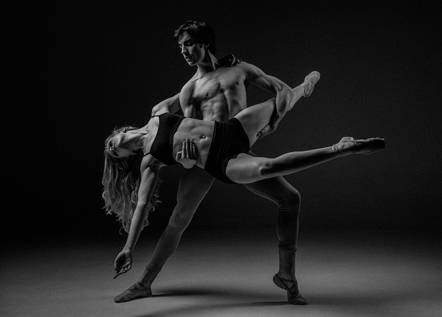 Dancers performing ballet on stage with abstract lighting