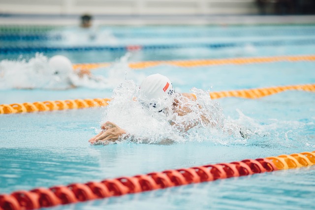 Diverse group of swimmers of various ages and backgrounds training together in a pool (swim team)