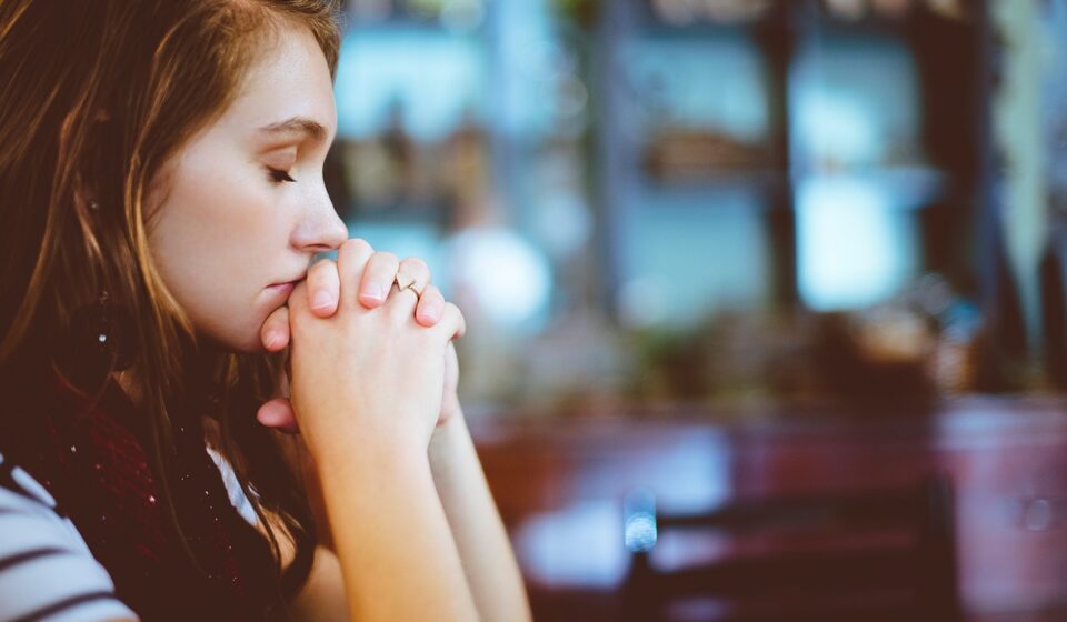 hands clasped in prayer