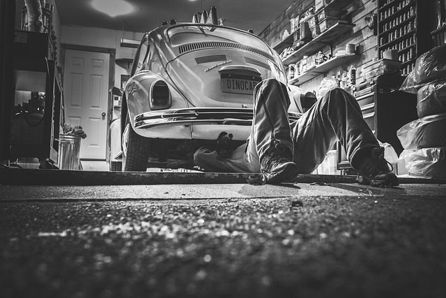 Mechanic checking transmission fluid level with dipstick