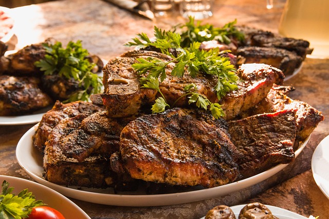 A platter of grilled mackerel fillets with lemon wedges and herbs