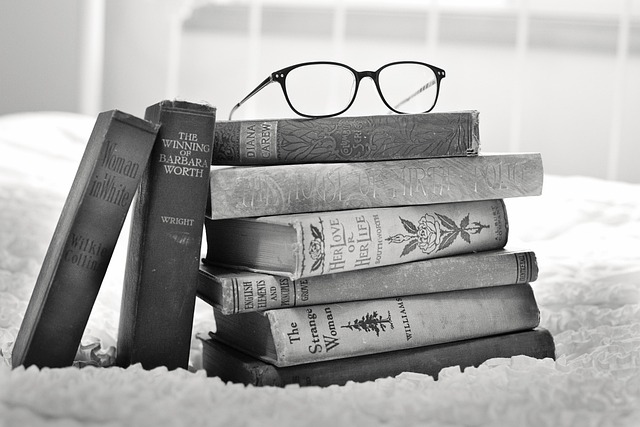 Stack of old books on a wooden table