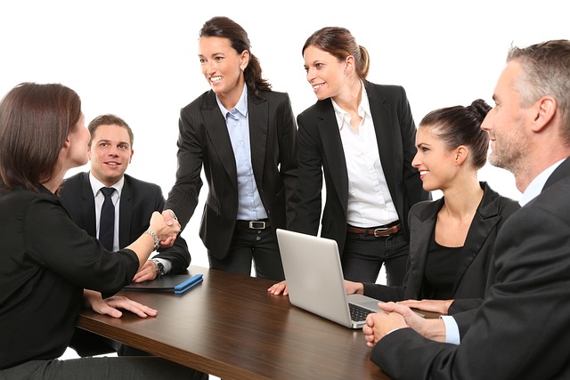 Team members in a meeting looking confused by a presentation slide (how to improve communication skills)