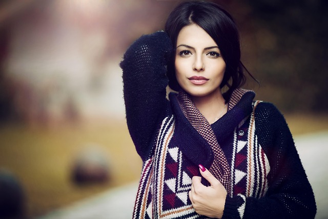 A woman in a beige knit sweat set, white sneakers, and a camel teddy coat